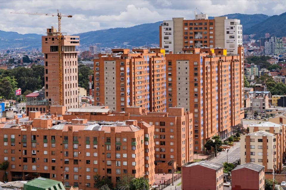 Brick apartment buildings in Bogotá, with the hills in the background.